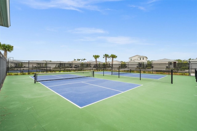 view of tennis court with basketball hoop