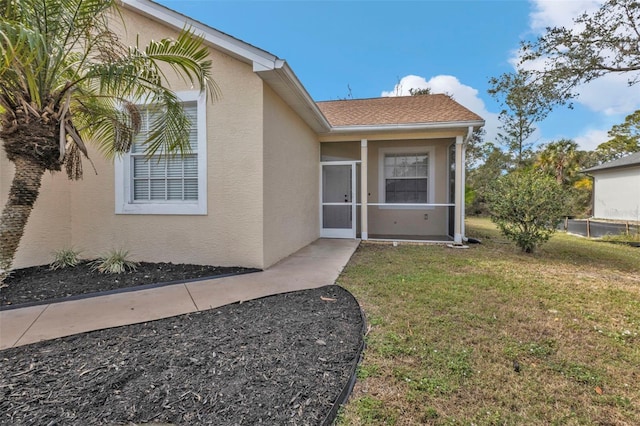 doorway to property with a yard