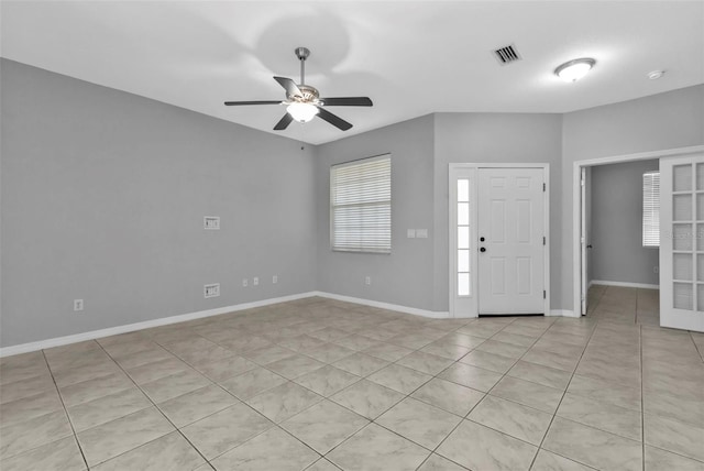 foyer entrance with ceiling fan and light tile patterned floors