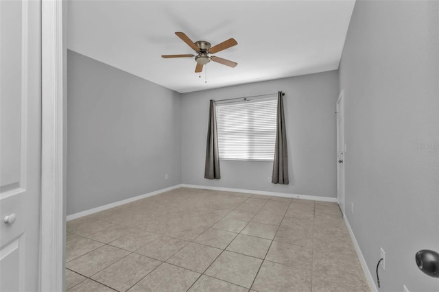 unfurnished room with ceiling fan and light tile patterned floors