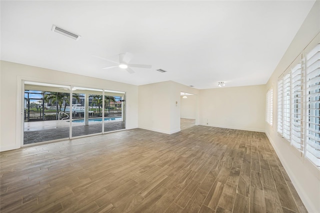 unfurnished living room with plenty of natural light and hardwood / wood-style floors