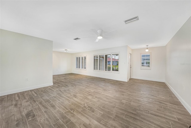 unfurnished room featuring ceiling fan and light wood-type flooring