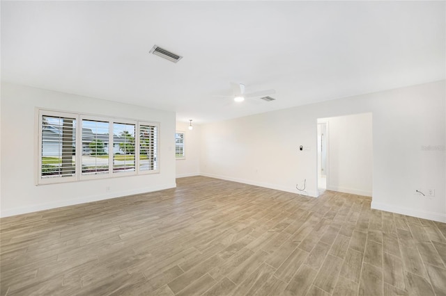 spare room with light hardwood / wood-style flooring and ceiling fan