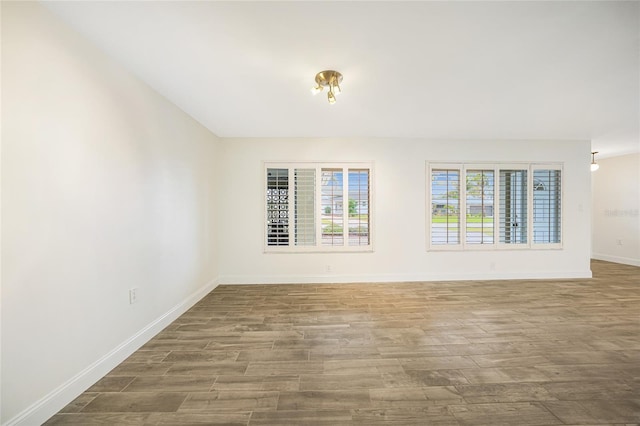 spare room featuring wood-type flooring