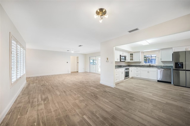 kitchen featuring stainless steel appliances, sink, light hardwood / wood-style floors, and white cabinets