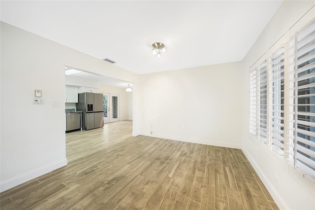 unfurnished living room with light hardwood / wood-style flooring