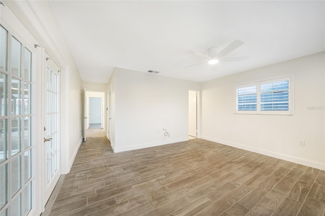 spare room featuring hardwood / wood-style flooring and ceiling fan