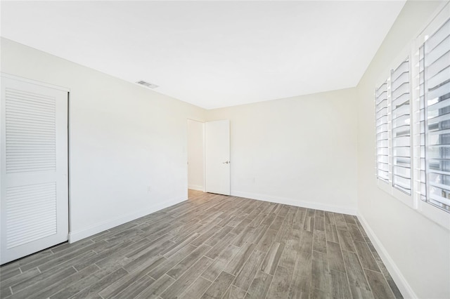 unfurnished room with wood-type flooring