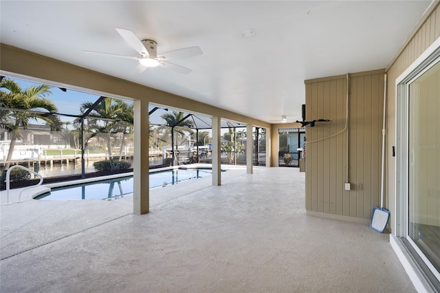 view of swimming pool with a water view and ceiling fan