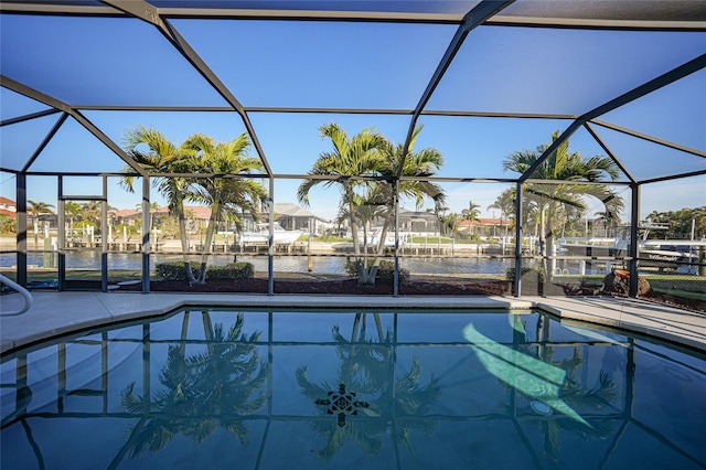 view of pool with a water view and glass enclosure