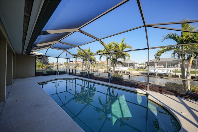 view of pool featuring a lanai, a patio area, and a water view