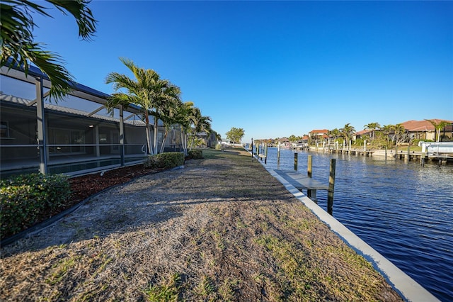 dock area featuring a water view and glass enclosure