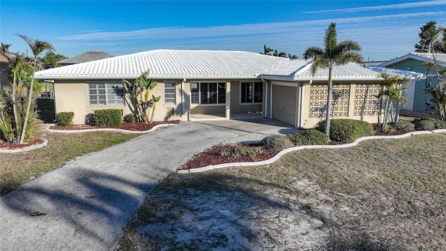 back of property with a garage and a lawn