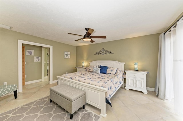 tiled bedroom featuring ceiling fan