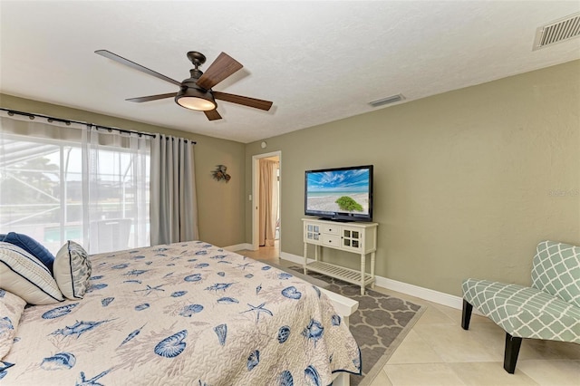 bedroom featuring light tile patterned floors, a textured ceiling, and ceiling fan