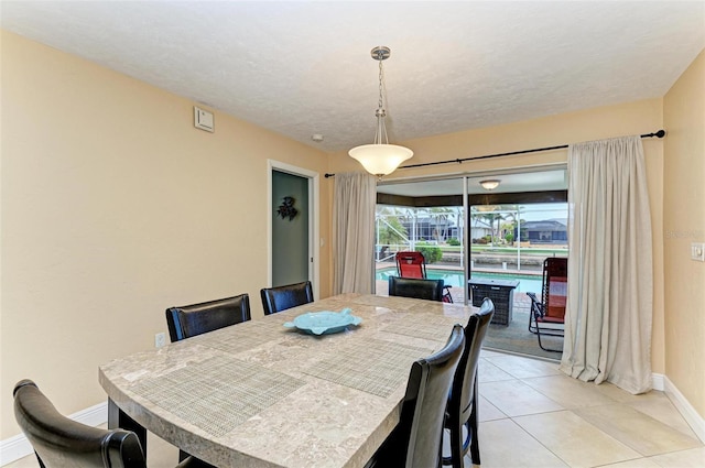 dining space featuring light tile patterned flooring