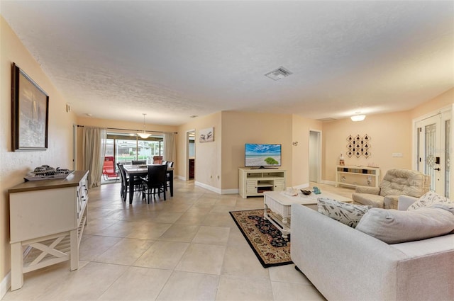 living room with light tile patterned floors and a textured ceiling