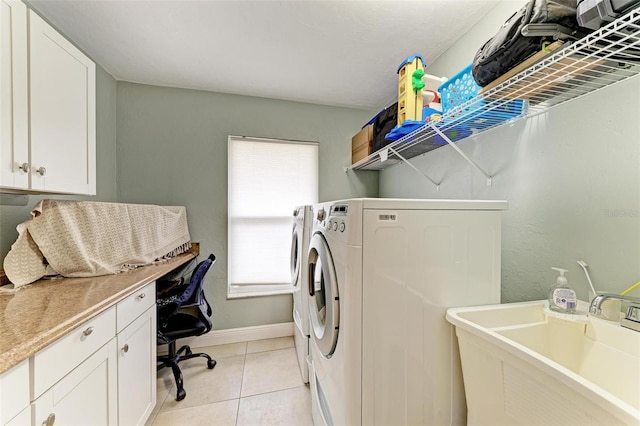 laundry room featuring light tile patterned flooring, sink, and washing machine and dryer