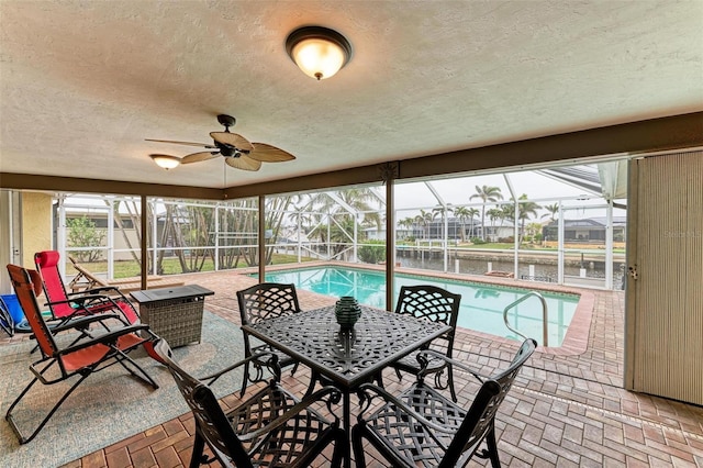 view of swimming pool with a water view, a lanai, and a patio