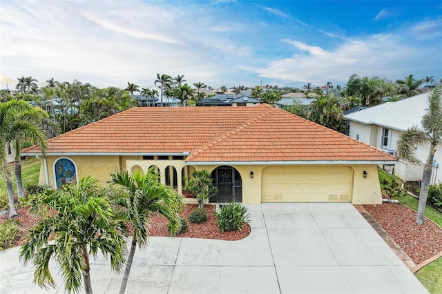 mediterranean / spanish-style home featuring a garage