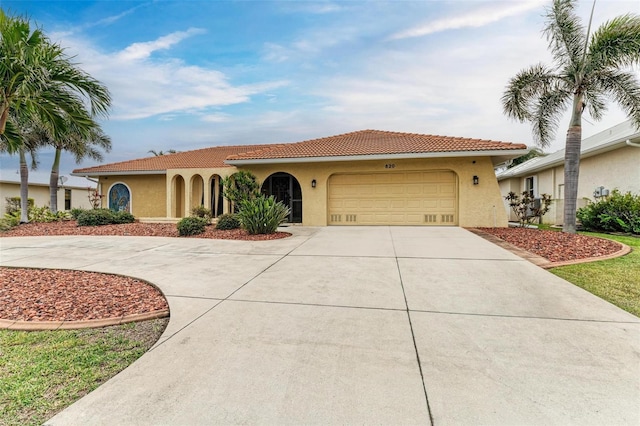 mediterranean / spanish-style house with a garage