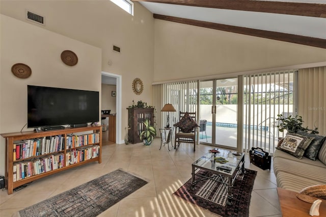 tiled living room featuring high vaulted ceiling and a wealth of natural light