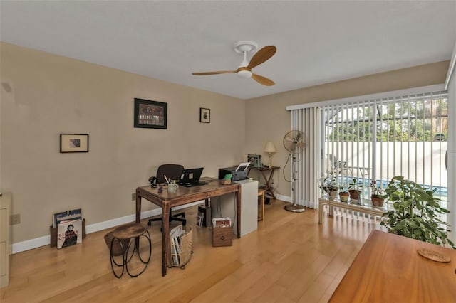 office area with light wood-type flooring and ceiling fan