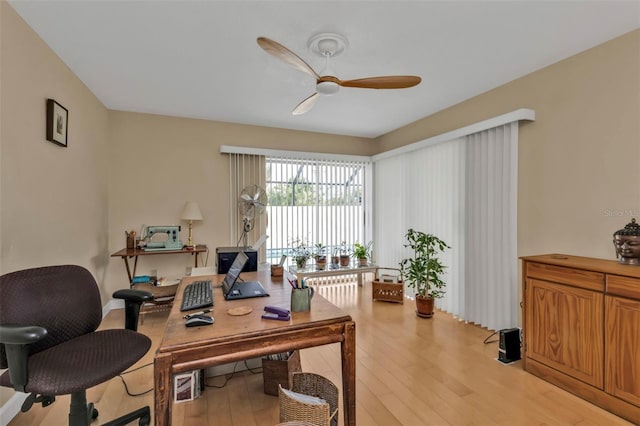 office area with light wood-type flooring and ceiling fan