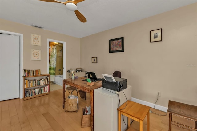 home office with ceiling fan and light hardwood / wood-style floors