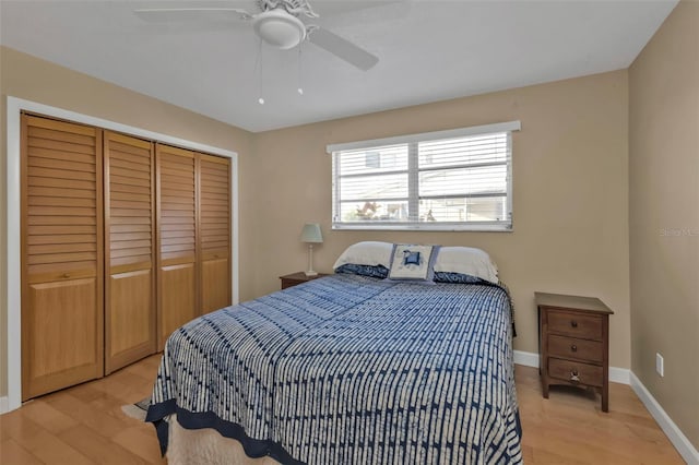 bedroom featuring light hardwood / wood-style floors, a closet, and ceiling fan