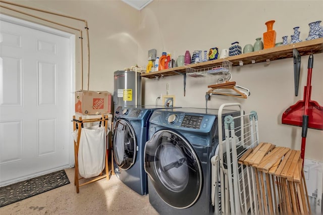 laundry area featuring washing machine and clothes dryer and electric water heater