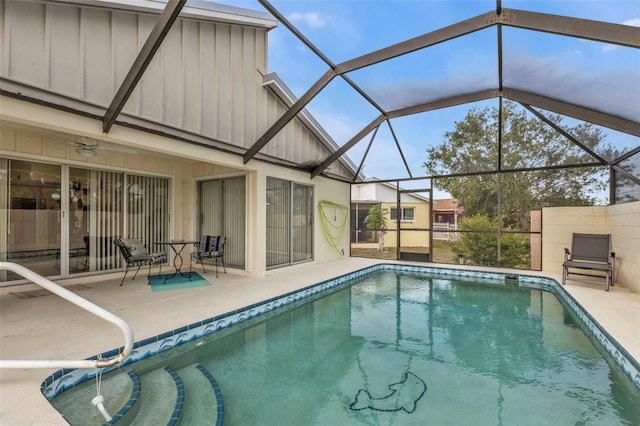 view of swimming pool featuring a lanai, a patio, and ceiling fan