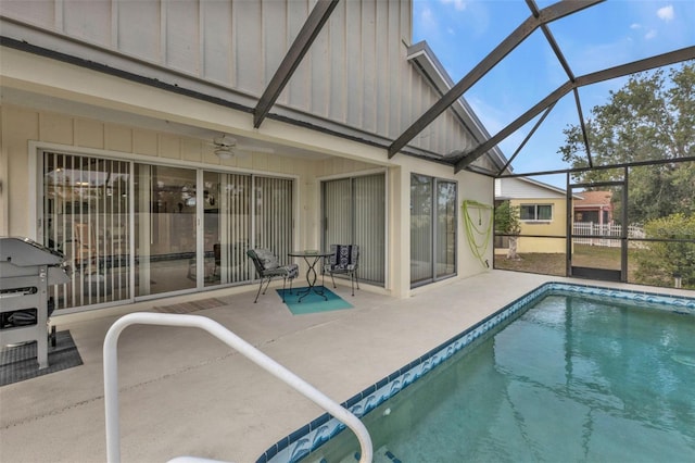 view of swimming pool featuring a lanai, a patio area, and ceiling fan