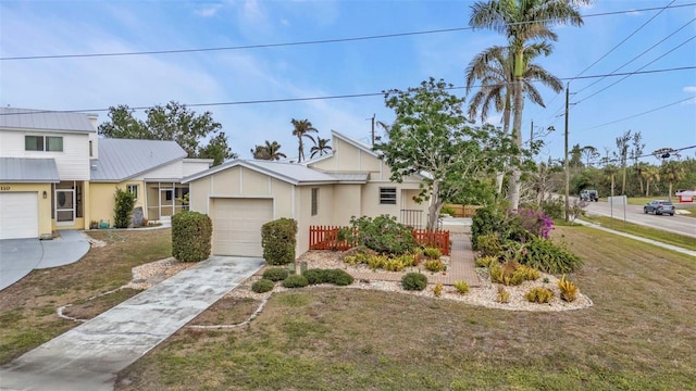 view of front of house with a garage and a front yard