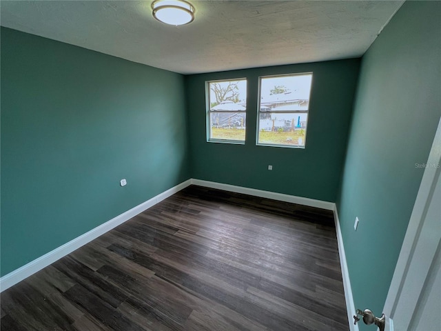 unfurnished room featuring dark hardwood / wood-style flooring