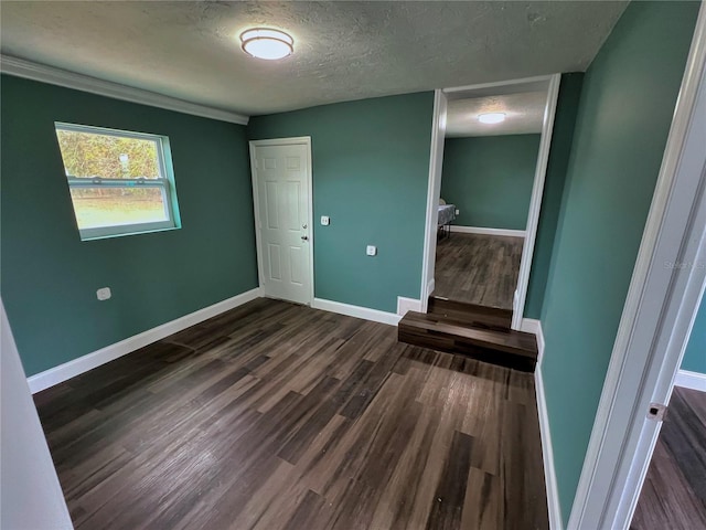 unfurnished bedroom featuring dark hardwood / wood-style floors and a textured ceiling