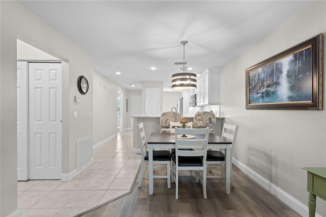 dining area featuring light wood-type flooring