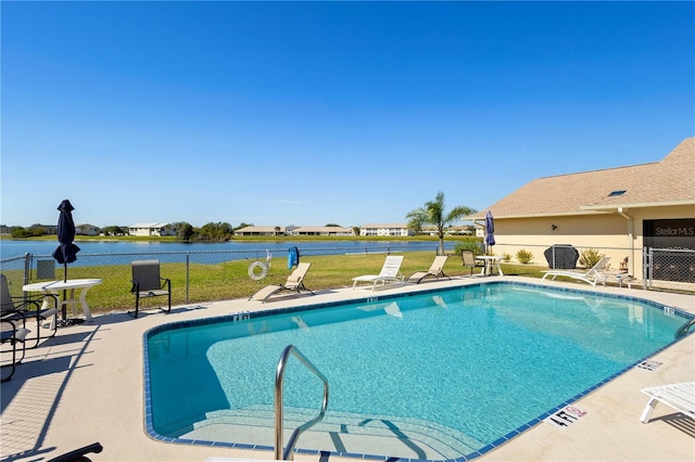 view of pool featuring a patio area and a water view