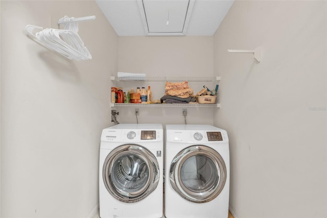 washroom with washing machine and clothes dryer