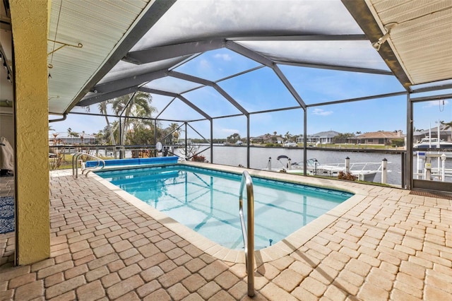 view of swimming pool with glass enclosure, a boat dock, a water view, and a patio