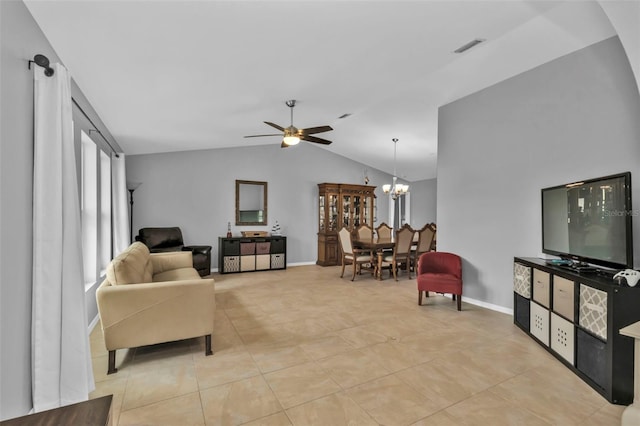 living room featuring ceiling fan with notable chandelier, light tile patterned floors, and lofted ceiling