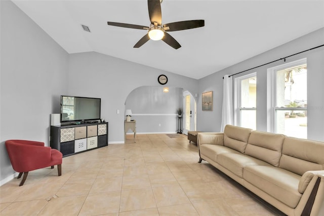 living room featuring ceiling fan, light tile patterned floors, and lofted ceiling