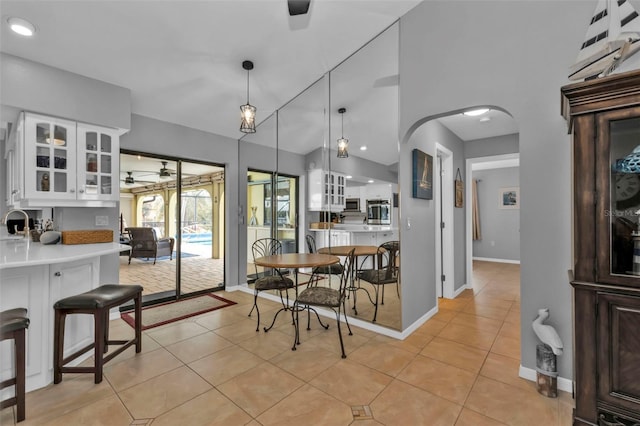 dining area featuring ceiling fan and light tile patterned flooring