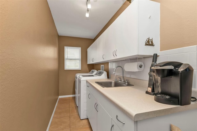 laundry area featuring cabinets, sink, independent washer and dryer, and light tile patterned flooring