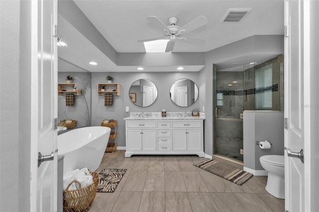 full bathroom with ceiling fan, toilet, vanity, and separate shower and tub