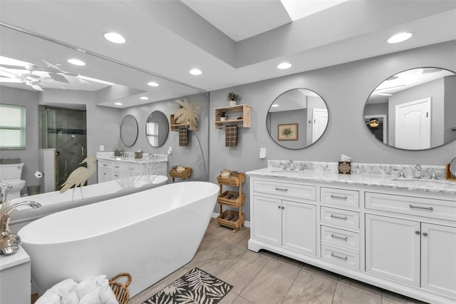 full bathroom featuring ceiling fan, toilet, vanity, and independent shower and bath