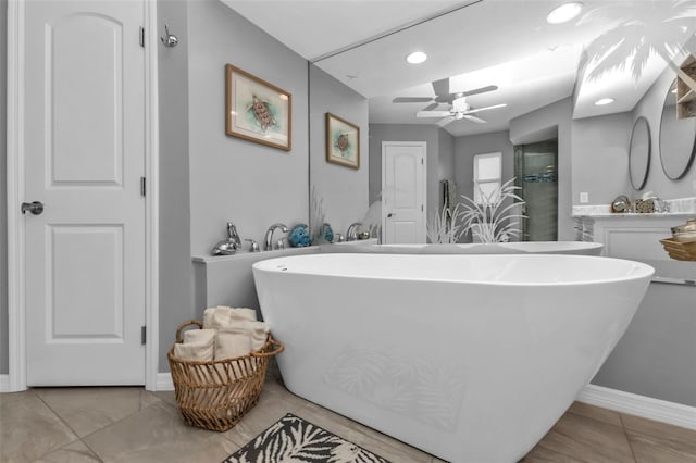 bathroom featuring a bath, ceiling fan, and vanity