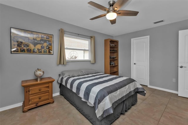 tiled bedroom featuring ceiling fan