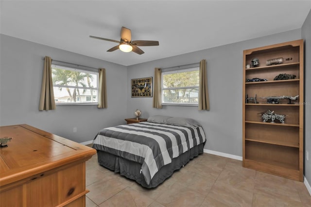 tiled bedroom featuring ceiling fan