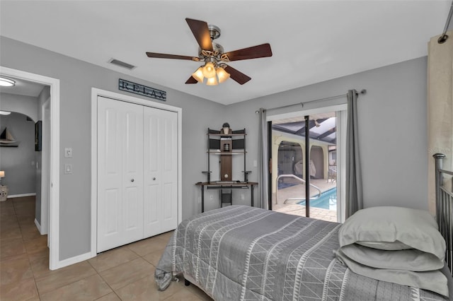 bedroom featuring a closet, ceiling fan, access to outside, and multiple windows